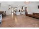 Open floor plan with kitchen, dining, and living spaces with hardwood floors and abundant natural light at 938 Moose Trl, Matthews, NC 28104