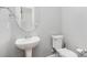 Well-maintained bathroom features a pedestal sink, a toilet, and neutral walls at 9832 Sunriver Rd, Huntersville, NC 28078