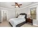 Comfortable bedroom features neutral tones, a ceiling fan, and a doorway leading to another area of the home at 9832 Sunriver Rd, Huntersville, NC 28078