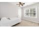 Simple bedroom with natural light, a single bed, and neutral colors for a cozy and minimalist space at 9832 Sunriver Rd, Huntersville, NC 28078
