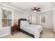 Bright bedroom with large windows, ceiling fan, and neutral decor for a relaxing and airy feel at 9832 Sunriver Rd, Huntersville, NC 28078