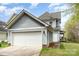 Charming home with a two-car garage, blue siding, and a well-maintained lawn for inviting curb appeal at 9832 Sunriver Rd, Huntersville, NC 28078