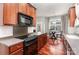 Well-equipped kitchen features stainless steel appliances, granite counters, and hardwood floors at 9832 Sunriver Rd, Huntersville, NC 28078