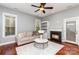 Inviting living room with hardwood floors, fireplace, and plenty of natural light at 9832 Sunriver Rd, Huntersville, NC 28078