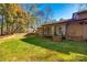 Backyard with a small patch of green grass, a brick wall, and a sunroom addition at 106 Jason Ct, Fort Mill, SC 29715