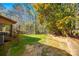 Green backyard featuring a brick retaining wall and an outdoor air conditioning unit at 106 Jason Ct, Fort Mill, SC 29715