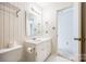 Bathroom with white cabinet vanity, large mirror, and vintage striped wallpaper at 106 Jason Ct, Fort Mill, SC 29715