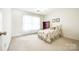 A bedroom featuring carpet, ceiling fan, bed, and a window at 106 Jason Ct, Fort Mill, SC 29715