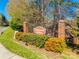 A welcoming sign at the entrance of Ashebrook Villas is surrounded by lush landscaping at 106 Jason Ct, Fort Mill, SC 29715