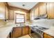 A kitchen with wood cabinets, countertop, stove, and sink at 106 Jason Ct, Fort Mill, SC 29715
