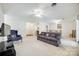 Open-concept living space with ceiling fan and views into kitchen and dining area at 106 Jason Ct, Fort Mill, SC 29715