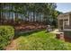 A spacious backyard with a lush lawn, grill, and views of the surrounding trees at 10728 Bere Island Dr, Charlotte, NC 28278