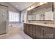 Bright bathroom features a large corner soaking tub, separate glass enclosed shower, and double sink vanity at 10728 Bere Island Dr, Charlotte, NC 28278