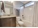 Well-lit bathroom featuring granite countertops, a framed mirror, and a shower/tub combination at 10728 Bere Island Dr, Charlotte, NC 28278