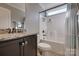 Bathroom featuring dark vanity, granite countertop and white shower with striped curtain and fixtures at 10728 Bere Island Dr, Charlotte, NC 28278