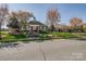 Charming community clubhouse with beautiful landscaping and blooming trees at 10728 Bere Island Dr, Charlotte, NC 28278