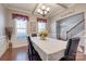 Inviting dining room featuring hardwood floors, wainscoting, and a decorative chandelier at 10728 Bere Island Dr, Charlotte, NC 28278