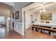 Elegant dining room boasts hardwood floors, detailed molding, coffered ceiling, and stylish chandelier at 10728 Bere Island Dr, Charlotte, NC 28278