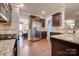Well-lit kitchen with stainless steel appliances, granite countertops, dark wood cabinets, and beautiful hardwood floors at 10728 Bere Island Dr, Charlotte, NC 28278
