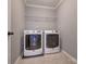 Laundry room featuring modern machines, tile floor, with wire rack for additional storage space at 10728 Bere Island Dr, Charlotte, NC 28278