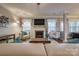 Inviting living room with hardwood floors, a fireplace, and comfortable seating at 10728 Bere Island Dr, Charlotte, NC 28278