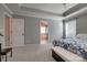 Large main bedroom with a tray ceiling, two windows, carpeted floors and a partial view into the ensuite at 10728 Bere Island Dr, Charlotte, NC 28278
