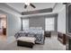Spacious main bedroom with tray ceiling, two windows, carpeted floors, and an elegant armoire at 10728 Bere Island Dr, Charlotte, NC 28278