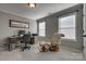 Home office area with desk, chair, filing cabinet, and view to the windows and chair with footstool at 10728 Bere Island Dr, Charlotte, NC 28278