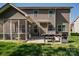 Outdoor patio featuring a grill and easy access to a screened porch at 10728 Bere Island Dr, Charlotte, NC 28278