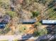 Top-down aerial perspective of a single-story home set amidst a wooded area at 1076 Percy Ln, Rockwell, NC 28138