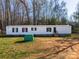 A cozy single-story home boasts a minimalist design and a peaceful setting at 1076 Percy Ln, Rockwell, NC 28138