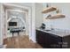 Wet bar with a sink, granite countertops, and decorative shelving, located near an open doorway at 109 Redbird Ln, Weddington, NC 28104