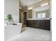 Luxurious bathroom featuring a soaking tub, a double vanity with sleek cabinets, and elegant fixtures at 109 Redbird Ln, Weddington, NC 28104