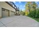 Spacious driveway leading to a two-car garage and a well-manicured lawn, providing ample parking and curb appeal at 109 Redbird Ln, Weddington, NC 28104