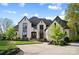 Beautiful two-story home with a circular driveway and a light colored brick exterior at 109 Redbird Ln, Weddington, NC 28104