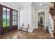 Bright foyer features hardwood floors, a double front door with glass panes and white trim at 109 Redbird Ln, Weddington, NC 28104