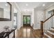 Bright foyer features hardwood floors, a front door with glass panes and white trim at 109 Redbird Ln, Weddington, NC 28104