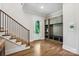 Foyer with hardwood floors, staircase, and built-in storage, leading to the outside at 109 Redbird Ln, Weddington, NC 28104