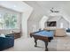 Spacious game room featuring a pool table, TV, and comfortable seating, ideal for entertainment at 109 Redbird Ln, Weddington, NC 28104