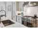 Close-up of a modern kitchen featuring stainless steel appliances and white subway tile backsplash at 109 Redbird Ln, Weddington, NC 28104