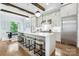 Modern kitchen with stainless steel appliances, a large island, and a dining area with outside view at 109 Redbird Ln, Weddington, NC 28104