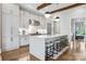 Well-lit kitchen with stainless steel appliances, white cabinetry, and seating at the island at 109 Redbird Ln, Weddington, NC 28104