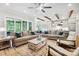 Spacious living room with large sofas, stylish ceiling fan, and access to the outdoor living space at 109 Redbird Ln, Weddington, NC 28104