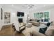 Bright living room with a fireplace, ceiling fan and sliding doors to the backyard at 109 Redbird Ln, Weddington, NC 28104