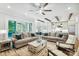 Open concept living room with view of the kitchen featuring wood beams and sliding doors at 109 Redbird Ln, Weddington, NC 28104