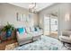 Comfortable living room with modern decor, a stylish sofa, and a large window for natural light at 109 Redbird Ln, Weddington, NC 28104