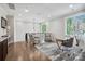 Open loft area with seating, a desk, and large windows providing plenty of natural light at 109 Redbird Ln, Weddington, NC 28104