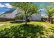 Expansive backyard showcasing a well-manicured lawn, mature tree shading, and a wood privacy fence at 11222 Huntington Meadow Ln, Charlotte, NC 28273
