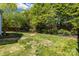 Green backyard with mature landscaping and lawn with privacy fence at 11222 Huntington Meadow Ln, Charlotte, NC 28273
