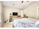 Bedroom featuring light walls, neutral carpet, a television sitting on a wood dresser, and a ceiling fan at 11222 Huntington Meadow Ln, Charlotte, NC 28273